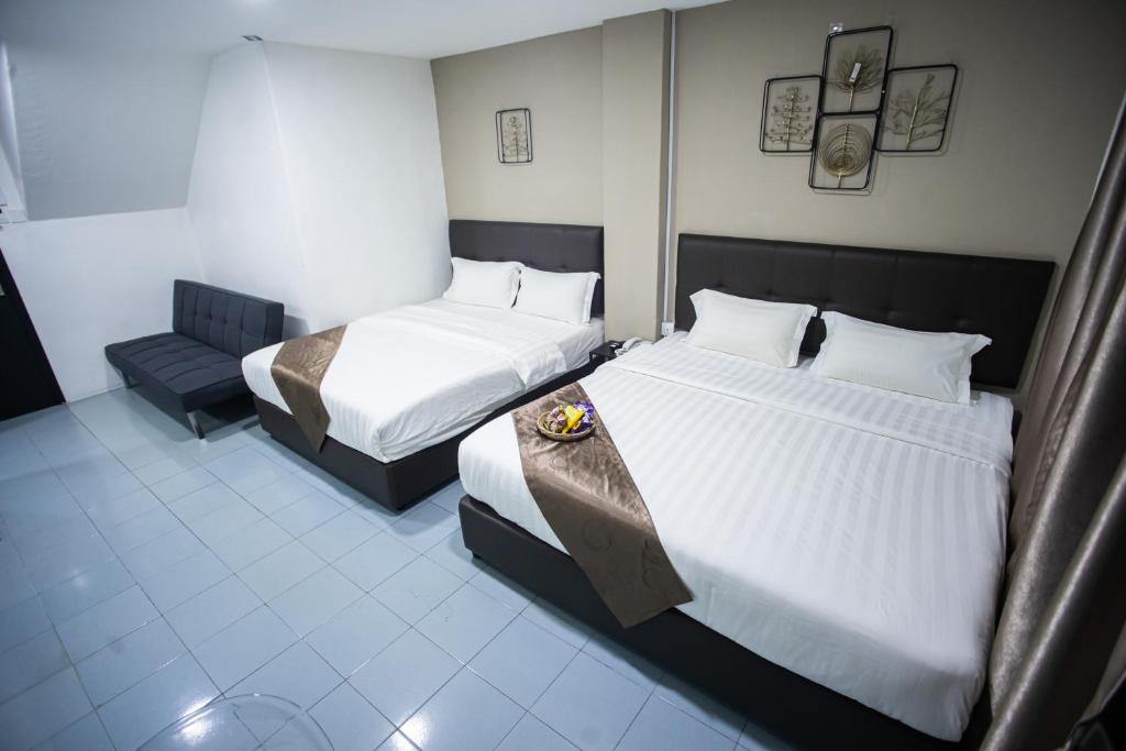 Postel nebo postele na pokoji v ubytování Rex City Hotel