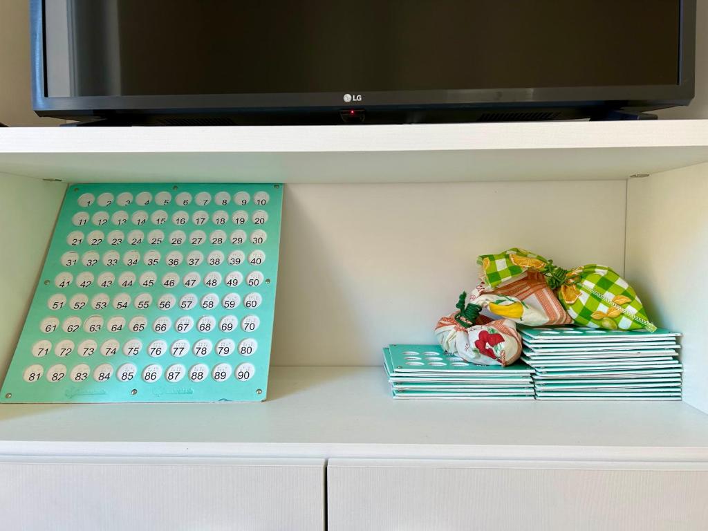 a white cabinet with a tv on top at Prospettiva Medina in Naples