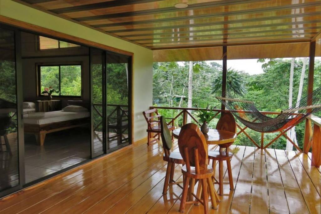 a living room with a hammock on a table at Villa Cecropia Drake in Drake
