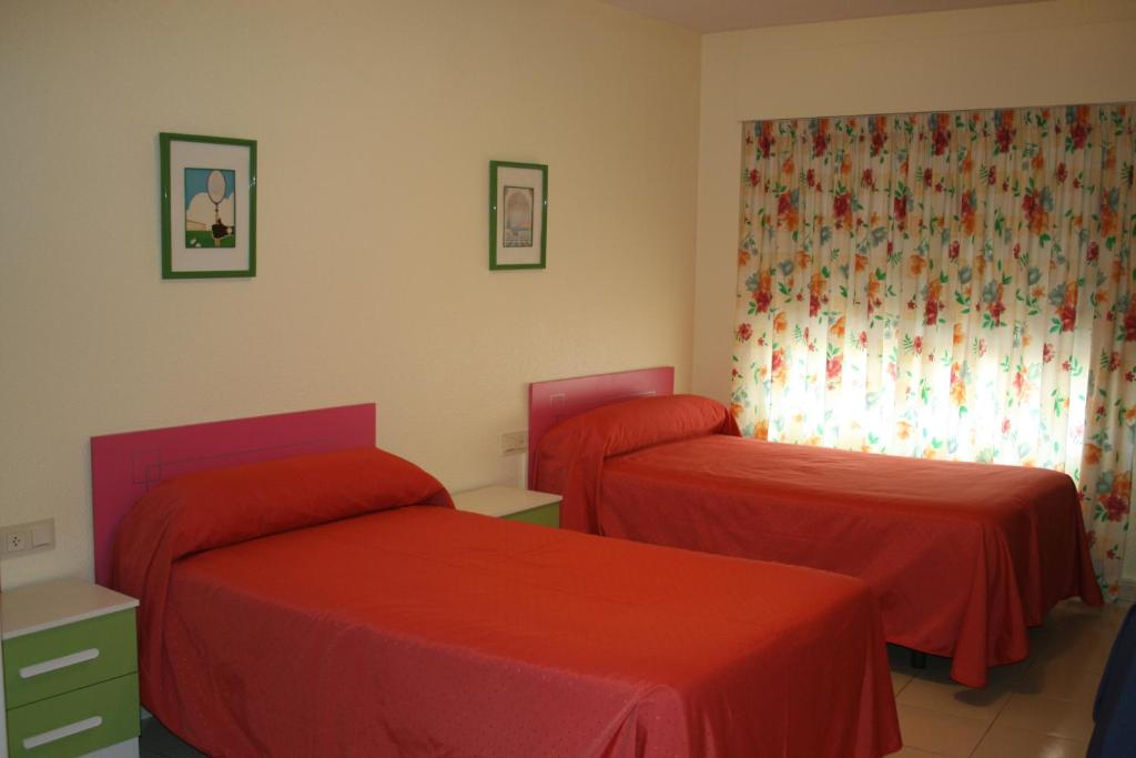Postel nebo postele na pokoji v ubytování Hostal Rosa