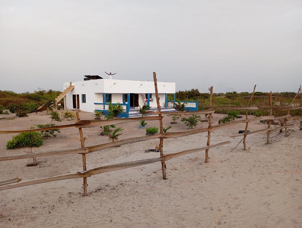 a house behind a fence on the beach at Baafeh Beach in Sanyang