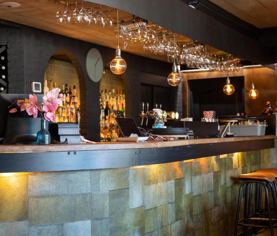a bar in a restaurant with a laptop on the counter at Hotel La Boutique in Nijmegen