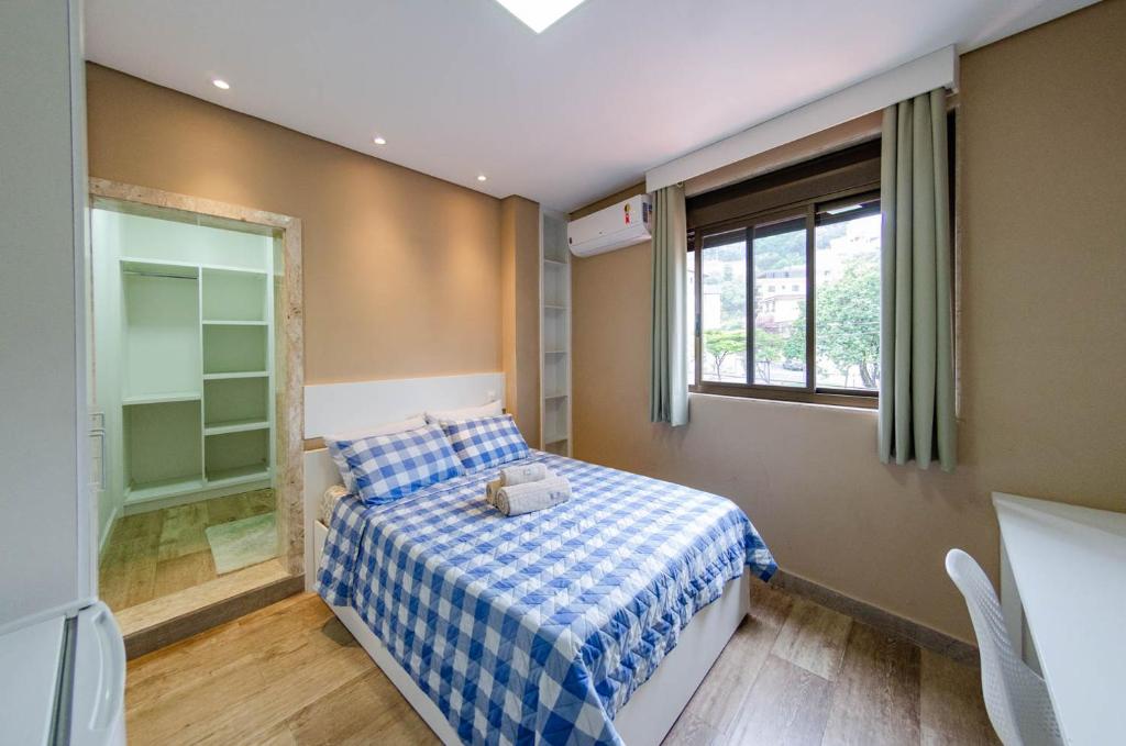 Ένα ή περισσότερα κρεβάτια σε δωμάτιο στο Prime Inn - Studios Coração Eucarístico