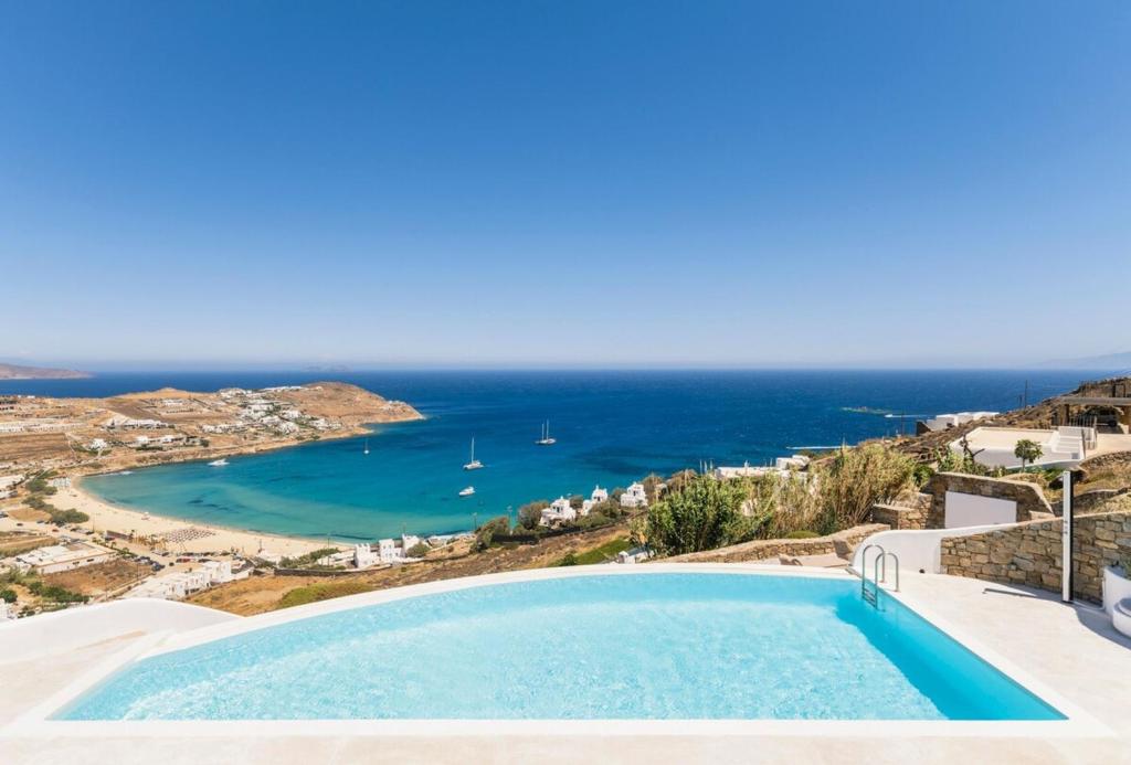 a pool with a view of the ocean at Luxury villa with stunning views above Kalo Livadi in Mýkonos City