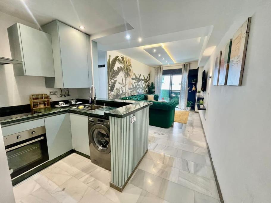 a kitchen with a washer and a washing machine in it at Jungle Vibes Stay - 2 BR Beach Front & Balcony in Tangier