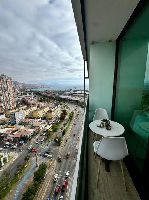 a balcony with a view of a city with traffic at PRO HOME Balmaceda III in Antofagasta