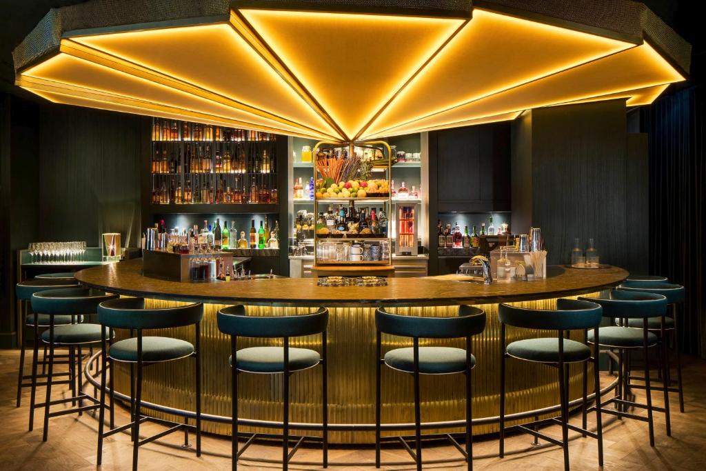 a bar with blue stools in a restaurant at Mandarin Oriental, Munich in Munich
