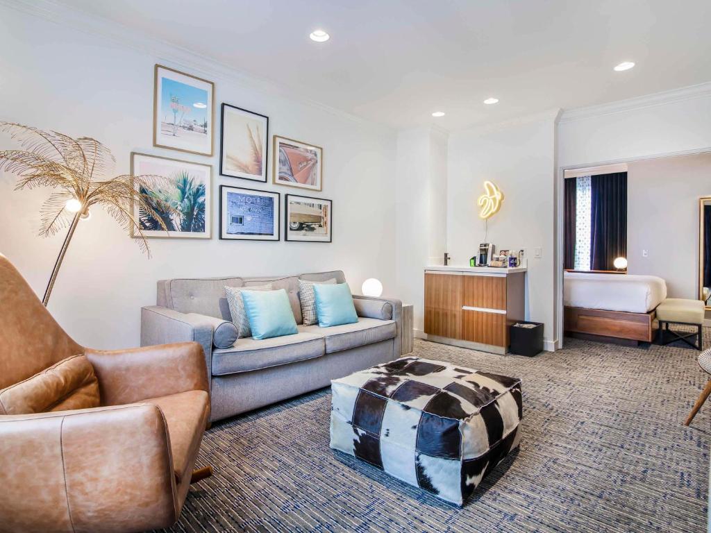 a living room with a couch and a table at Hotel Belmont Vancouver - MGallery Collection in Vancouver