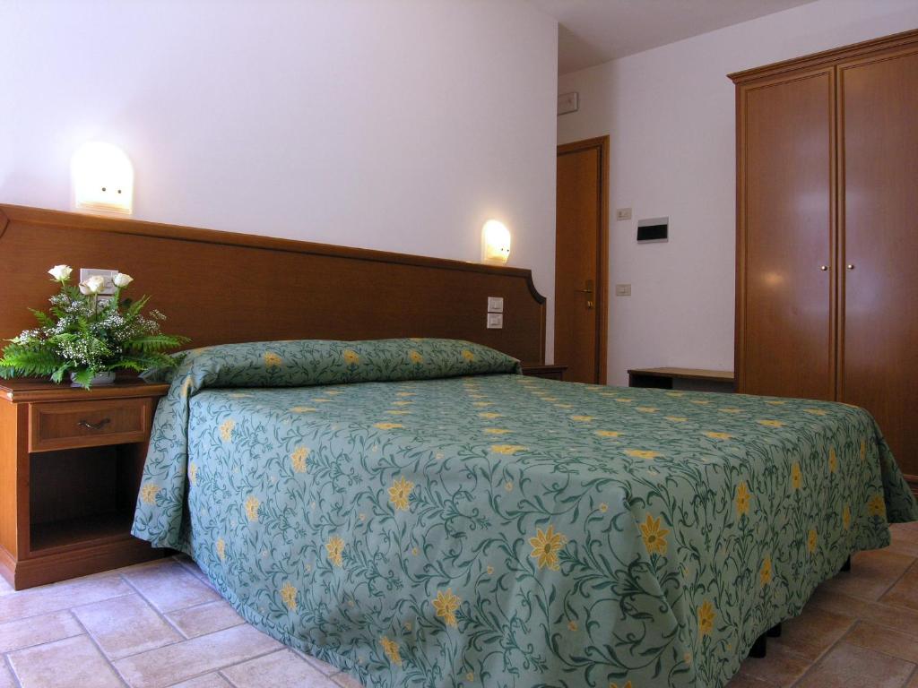 Postel nebo postele na pokoji v ubytování Hotel La Rocca