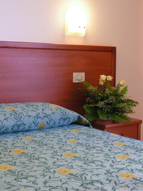 Postel nebo postele na pokoji v ubytování Hotel La Rocca