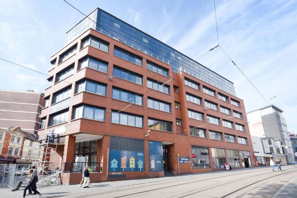 a tall brick building with people walking in front of it at Hydrogen in Nottingham in Nottingham