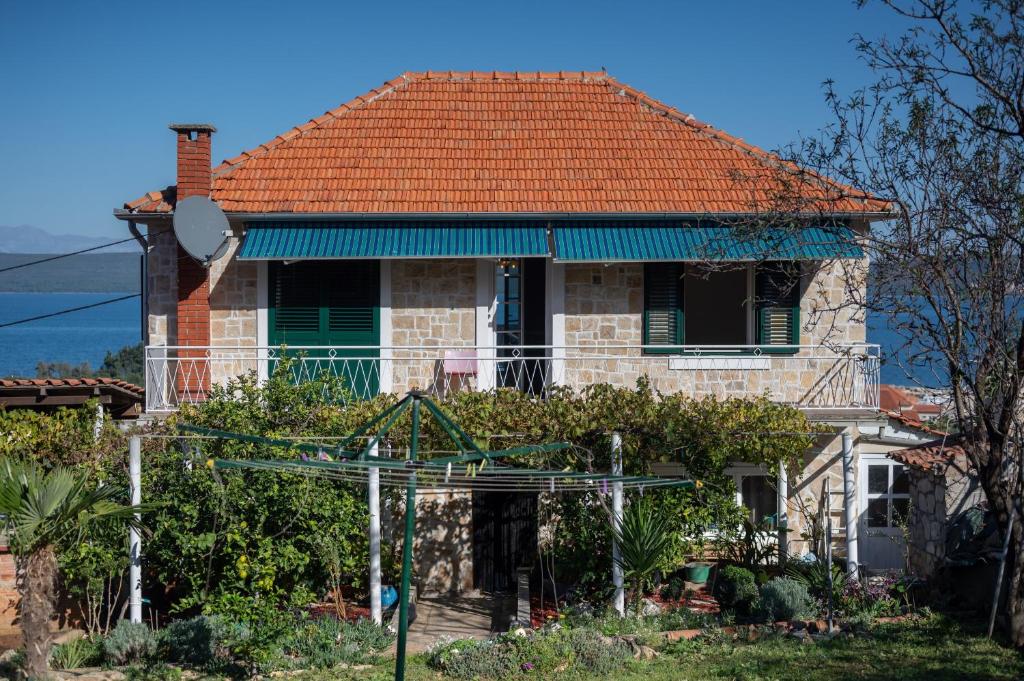a brick house with an orange roof at MY DALMATIA - Sea view holiday home Antonela in Dobropoljana