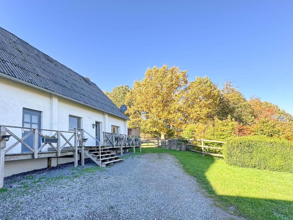 a building with a deck next to a yard at Landhaus Landgelück in Hellenthal