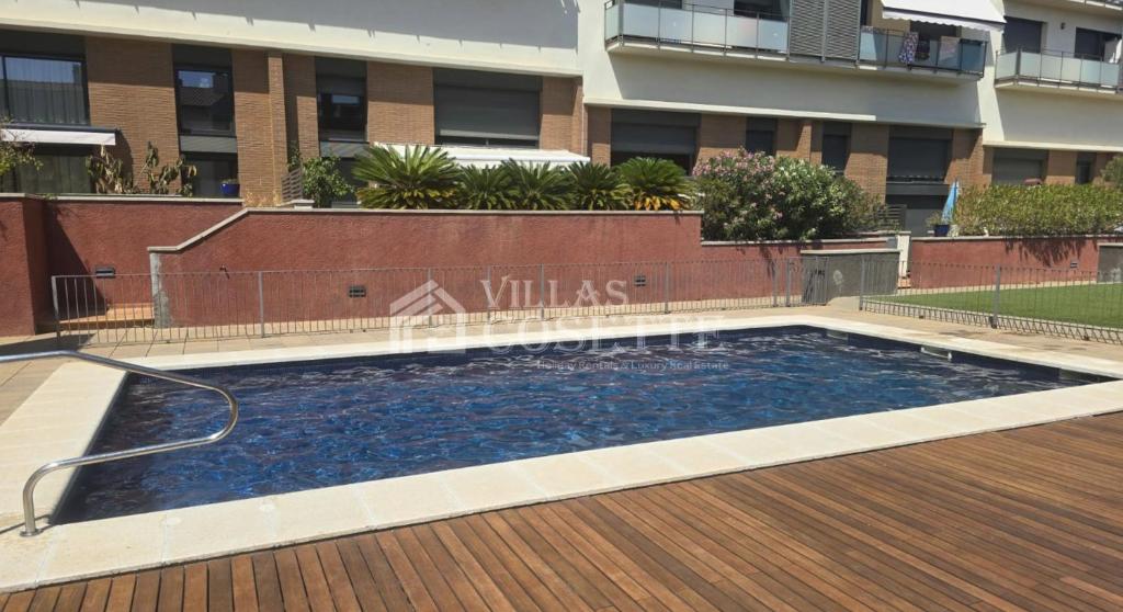a pool of water with a hose in front of a building at VILLAS COSETTE Apartamento CAMILLE in Sant Feliu de Guixols