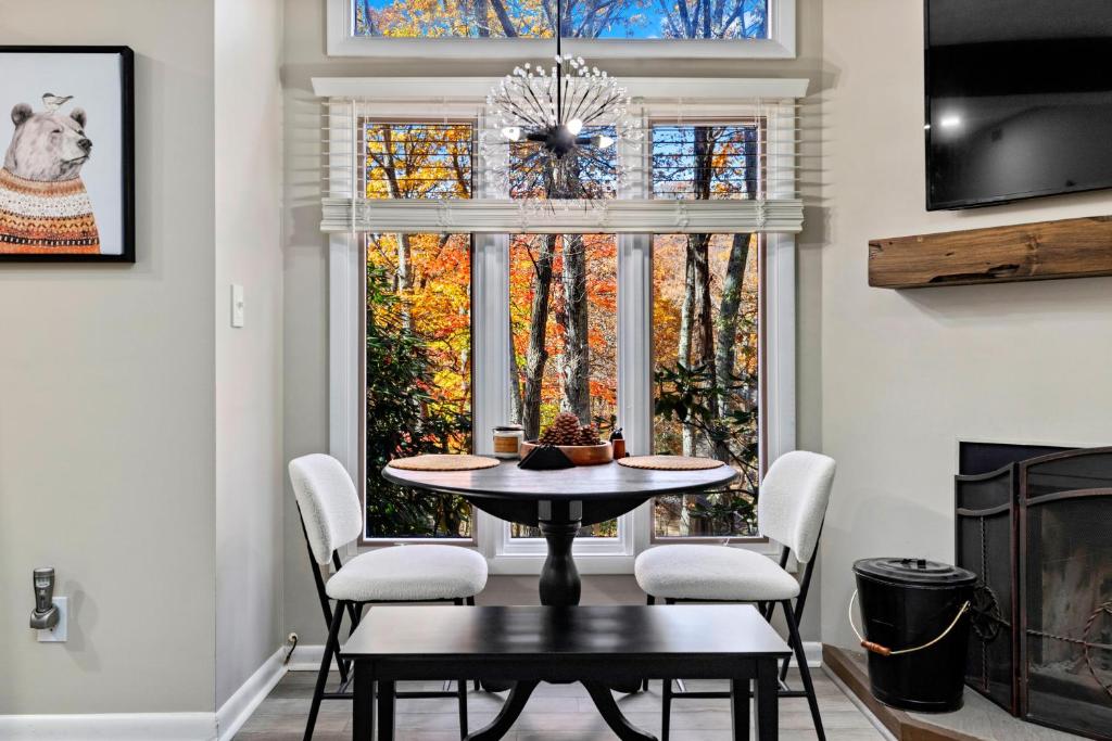 a dining room with a table and chairs and a window at Laurelwood 44 with Wintergreen Advantage in Wintergreen