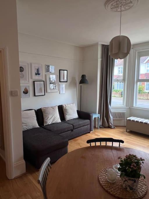a living room with a couch and a table at Seashell Apartment - Central location in Folkestone