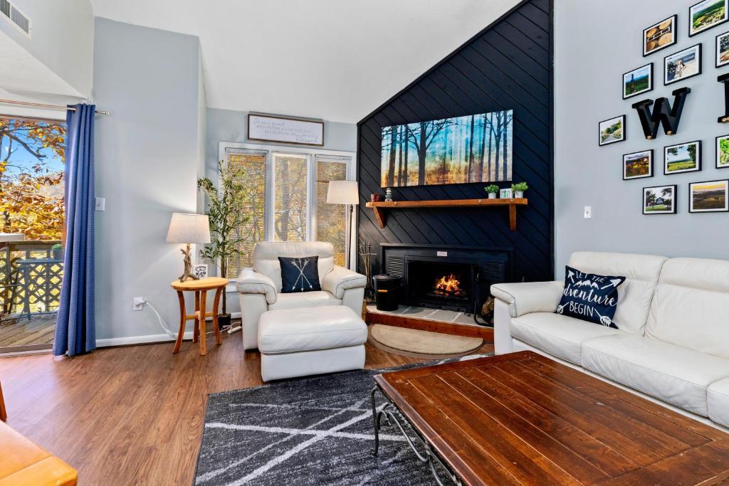 a living room with white furniture and a fireplace at Laurelwood 73 with Wintergreen Advantage in Wintergreen