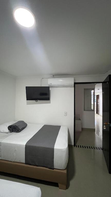 Postel nebo postele na pokoji v ubytování Hotel Medellín 66