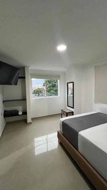 Postel nebo postele na pokoji v ubytování Hotel Medellín 66