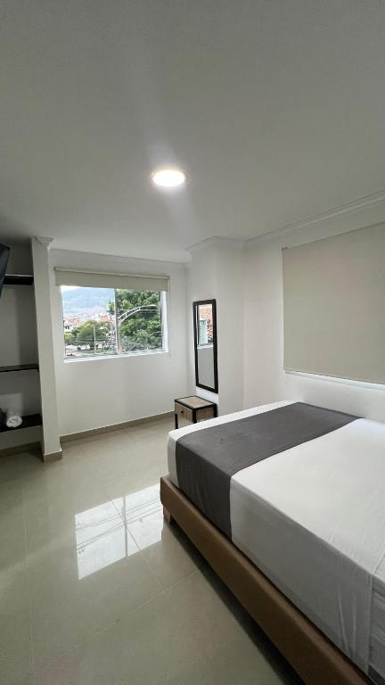 Postel nebo postele na pokoji v ubytování Hotel Medellín 66