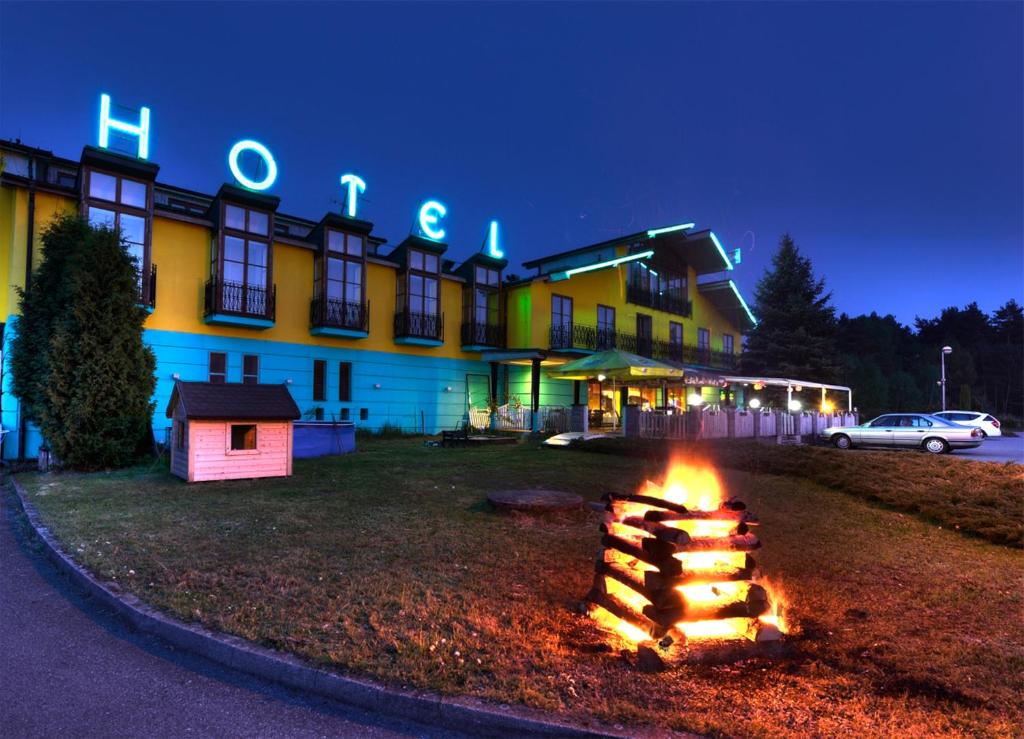 a fire in front of a building at night at Hotel Sloup in Soběslav