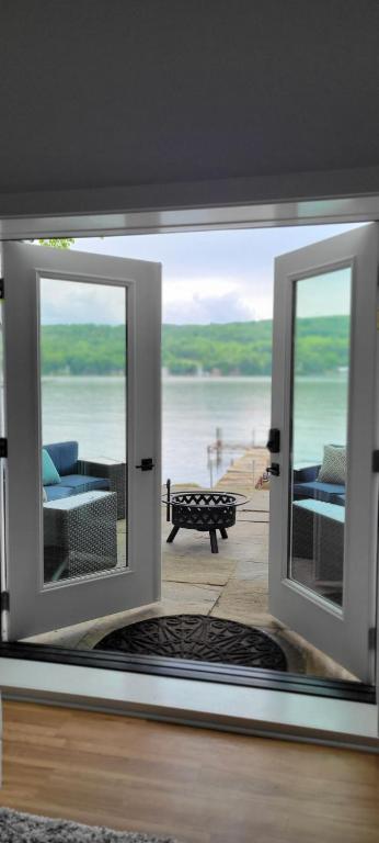 a view of a living room with a view of the water at Waneta Way Cottage in Hammondsport