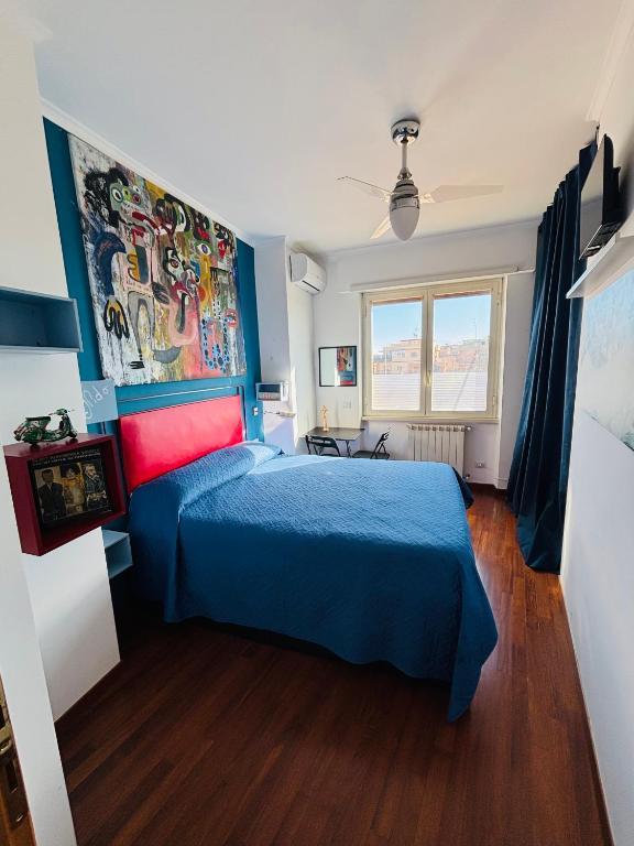 a bedroom with a blue bed with a blue comforter at Cubiculla Monte Mario in Rome