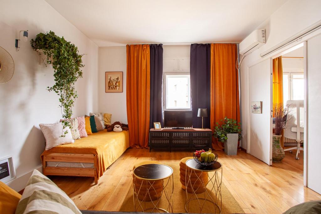 a living room with a couch and a table at Vânători Nest - 2 room - Pumo properties in Bucharest