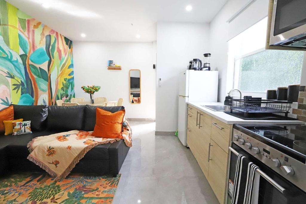 a living room with a black couch in a kitchen at Rooftop Retreat on Ocean Drive with Beach View in Miami Beach