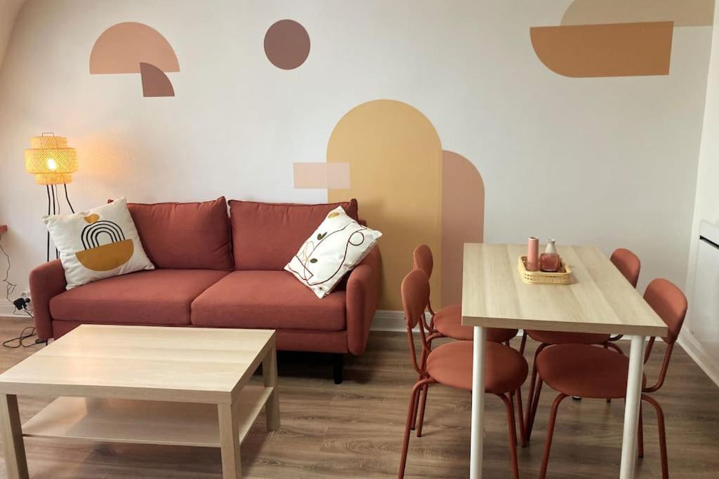 a living room with a couch and a table at Le Terracotta - joli duplex centre ville in Cherbourg en Cotentin
