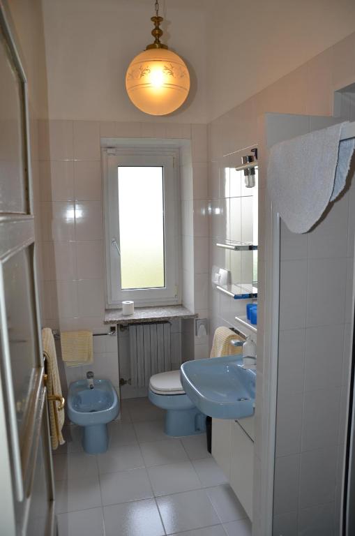 a bathroom with a sink and a toilet and a window at Hotel Villa Ruscello in Baveno