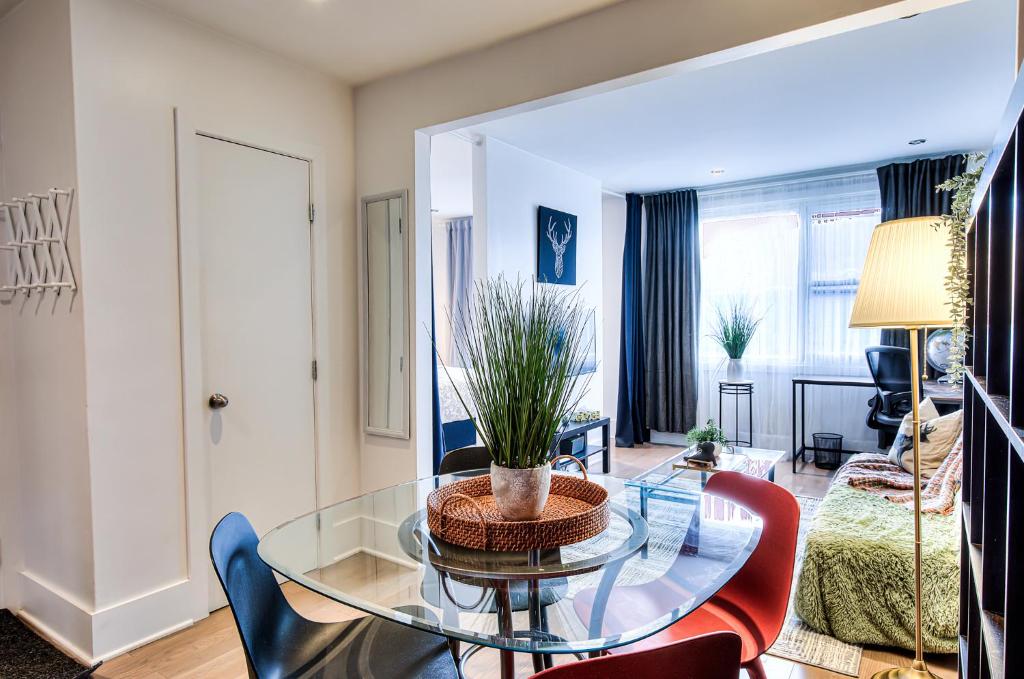 a living room with a glass table and chairs at Plateau Escape & Nightlife Adventures! Downtown Super Value! Full 1BR Apartments in Montréal