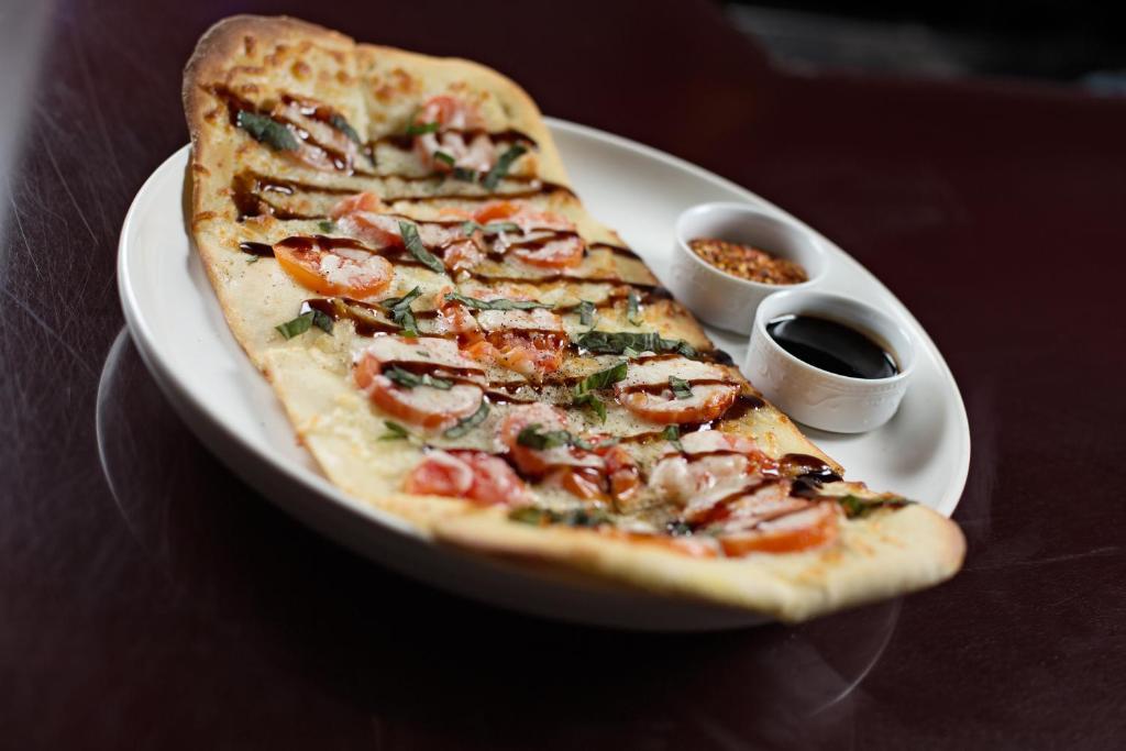 a slice of pizza on a plate on a table at Hotel Ruby in Spokane