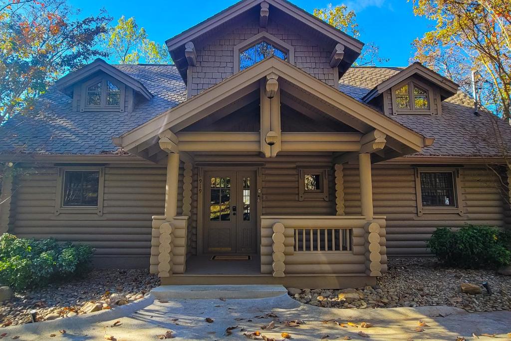 a log home with a front door and trees at 4 Pines Lodge in Gatlinburg