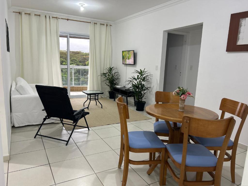 a living room with a table and chairs at Apartamento Poleto's in Bertioga