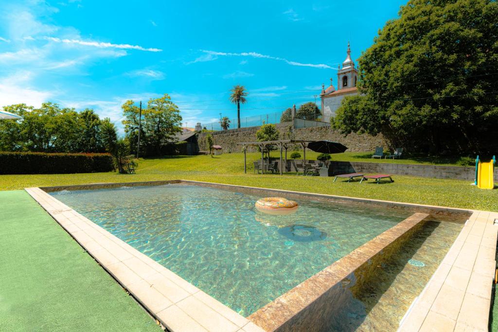 a swimming pool in the yard of a house at Quinta Sao Miguel de Arcos in Vila do Conde