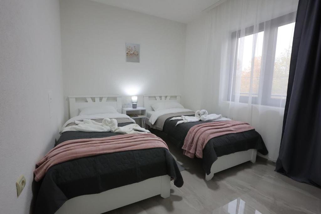 Postel nebo postele na pokoji v ubytování Ivan's guesthouse