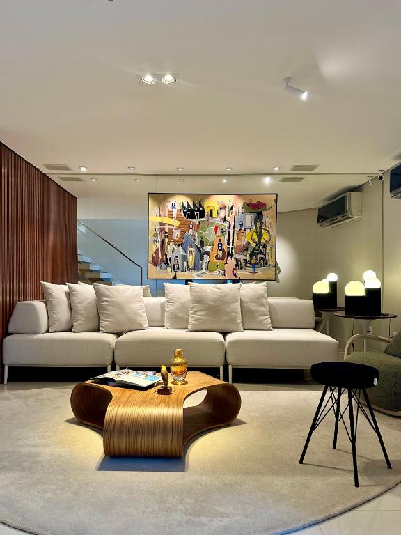 a living room with a couch and a table at Premier Apartment - Hotel Mercure Belém Boulevard in Belém
