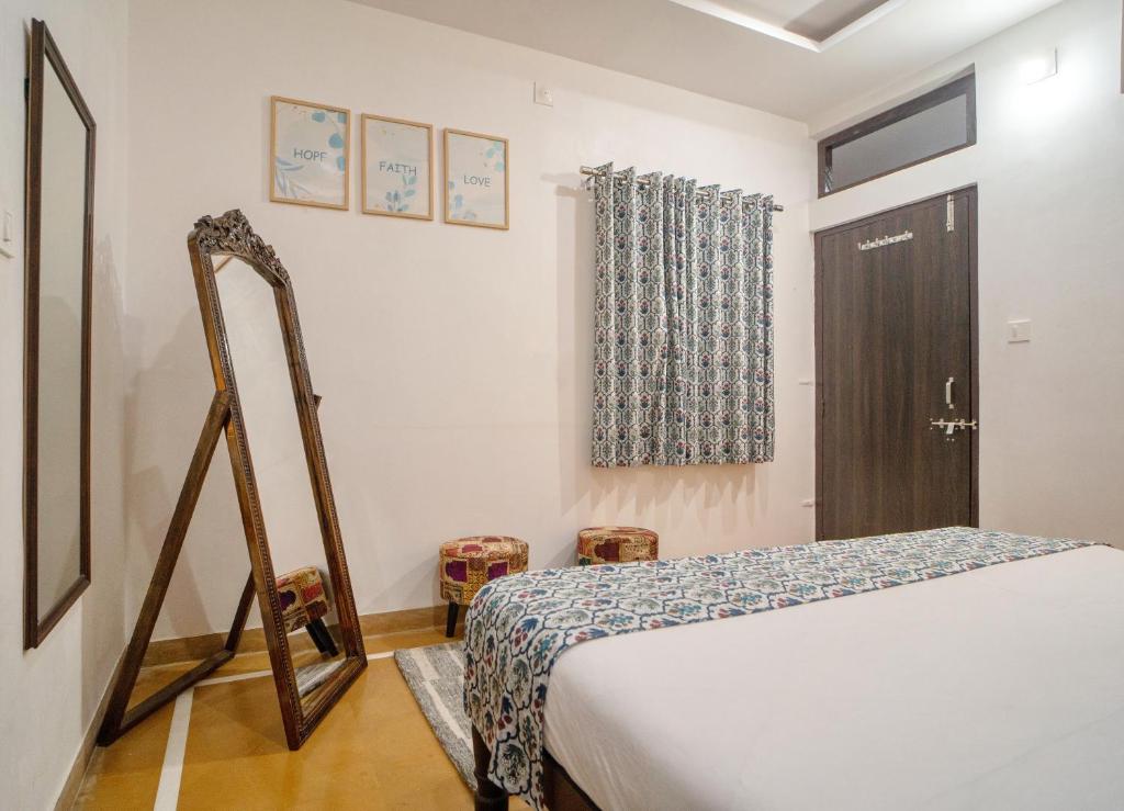 a bedroom with a bed and a window and a door at Haveli Palace - 2BHK Luxury Apartment in Udaipur