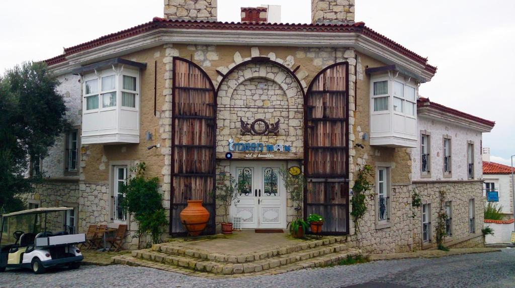 a house with an archway on the front of it at Imren Han Hotel - Special Category in Alaçatı