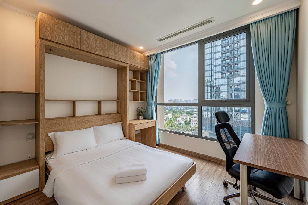 a bedroom with a bed and a desk and window at Vinhomes Landmark Luxury Apartment by Navie in Ho Chi Minh City