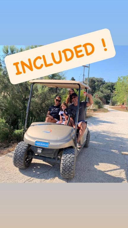 a group of people riding in a golf cart at Village Guest House in Corfu