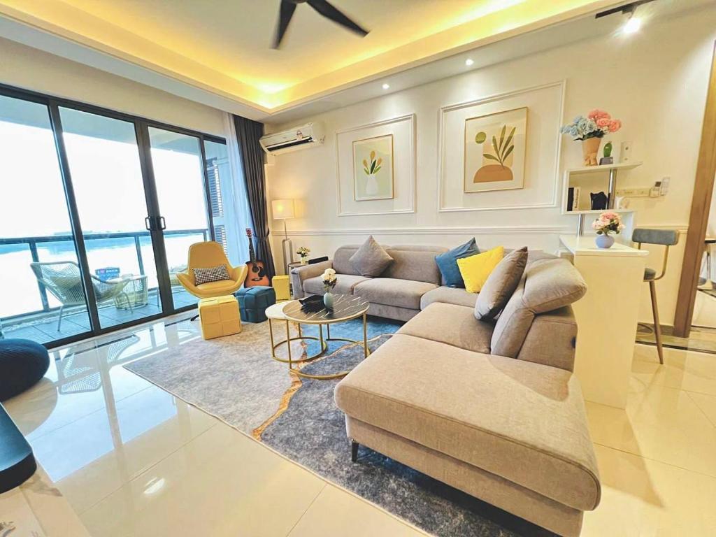 a living room with a couch and a table at R&F Seine Region at ANJU in Johor Bahru
