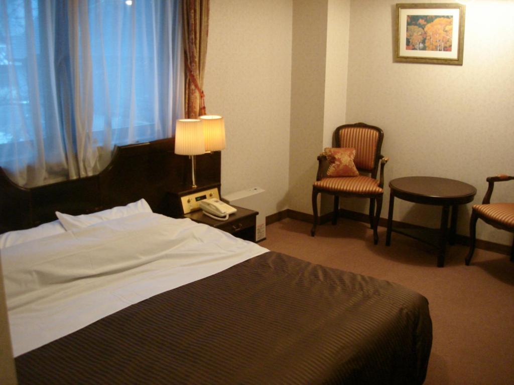 Postel nebo postele na pokoji v ubytování Hotel Soyokaze