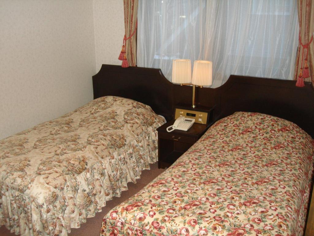 Postel nebo postele na pokoji v ubytování Hotel Soyokaze
