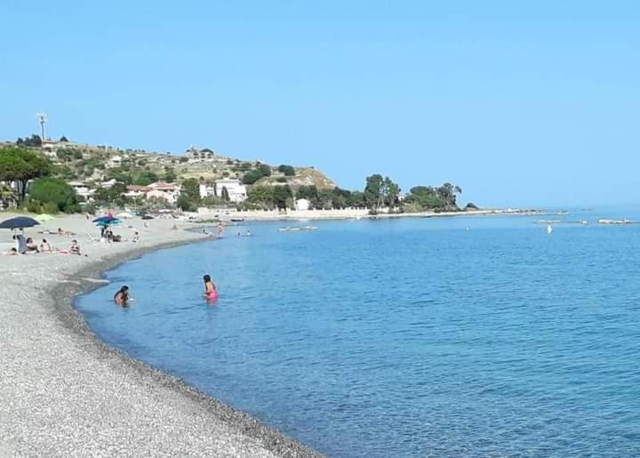 two children playing in the water at the beach at Appartamento in Residence La Vela in Palizzi Marina