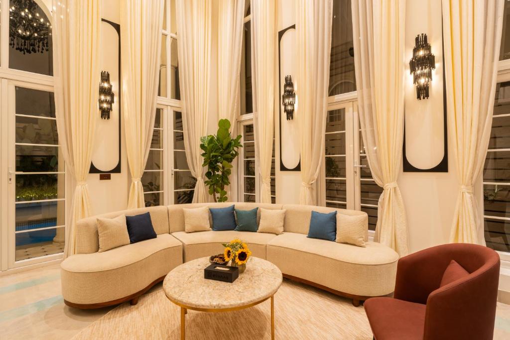 a living room with a couch and a table at ELIVAAS 4 BHK Villa with Pvt Pool & Jacuzzi-Yashgeet in Siolim