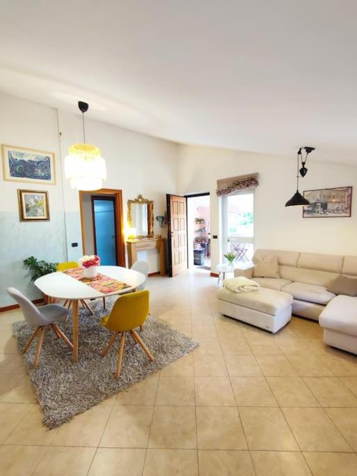 a living room with a table and a couch at Appartamento Hygge House in Montecatini Terme