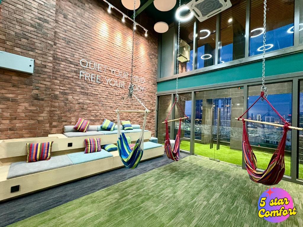 Habitación con 2 hamacas en un edificio en 5 Star Comfort Riveria City KL Sentral 4 pax infinity pool, en Kuala Lumpur