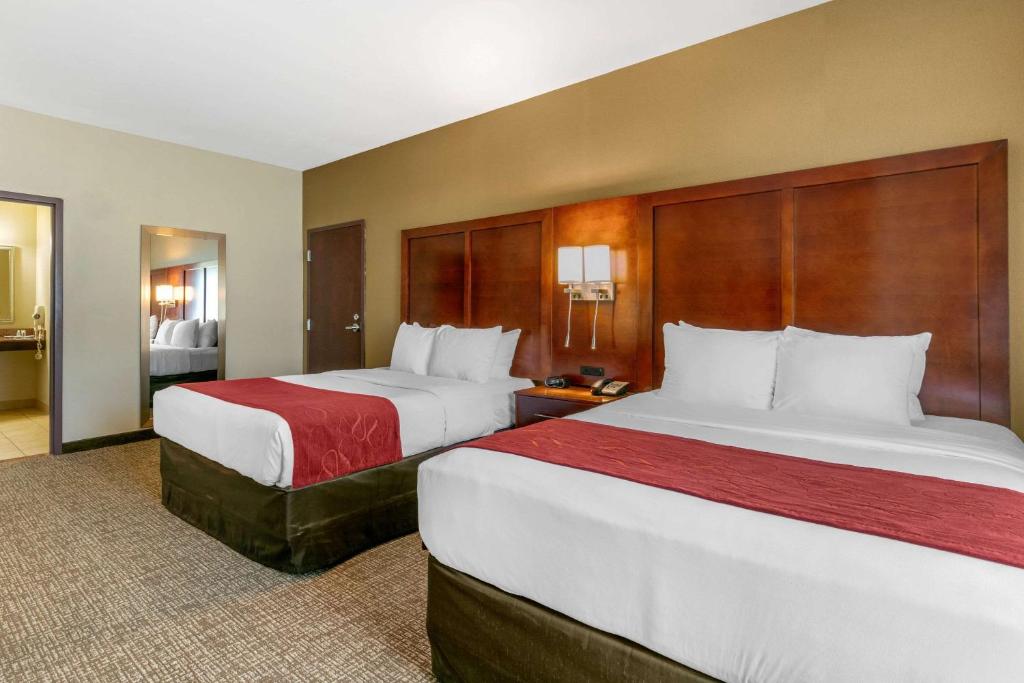 two beds in a hotel room with two at Comfort Suites in Forrest City